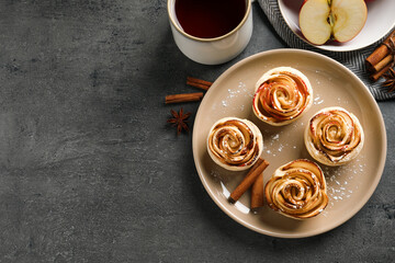 Freshly baked apple roses on grey table, flat lay. Space for text