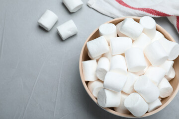 Fototapeta na wymiar Delicious puffy marshmallows on grey table, flat lay. Space for text