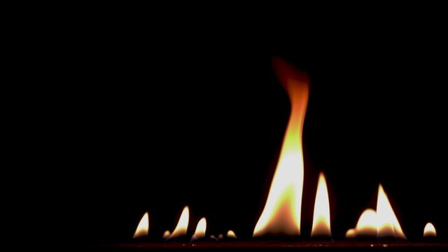 B roll of Close-up of flames burning slow motion background footage. Flames fire on black background. Burning fire. Bonfire. 