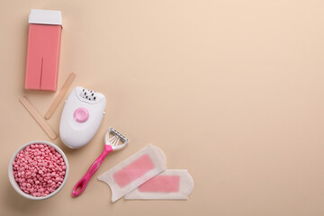 Set of epilation products on beige background, flat lay. Space for text