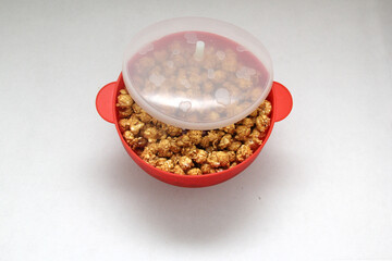 Microwave freshly made caramel popcorn with drinks, all ready to watch series, movies or tv shows
