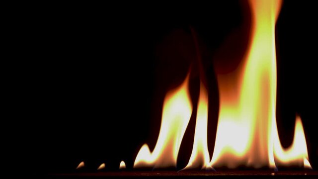 B roll of Close-up of flames burning slow motion background footage. Flames fire on black background. Burning fire. Bonfire. 