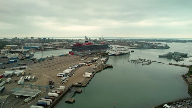Cruise Ships, Yachts, And Boats Docked At The Harbour Of Portsmouth In United Kingdom. aerial descend