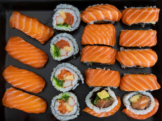 Sake Sushi Nigiri, Maki Rolls with Salmon on a black plate