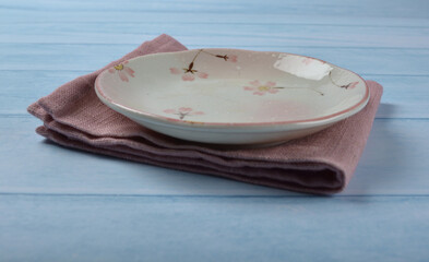 asian Japan pink ceramic bowl and plate drawing design with pink cloth and wood board on blue wood table dinnerware