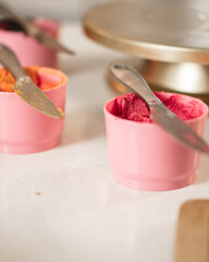 Pink bowls with buttercream with colored food coloring to decorate a cake