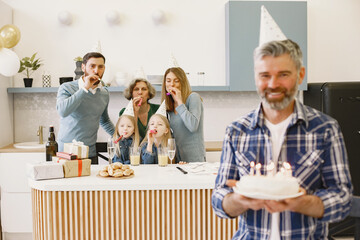 Family celebrating birthday in the kitchen