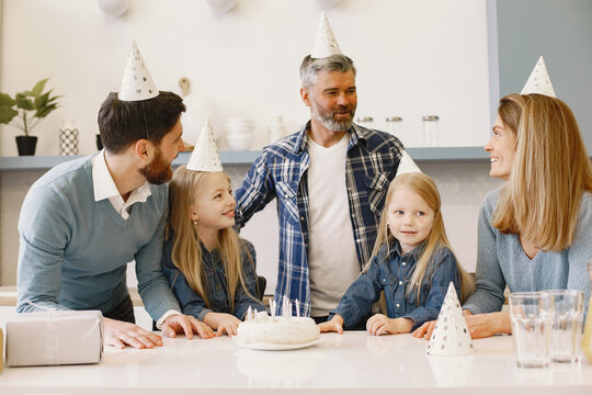 Family celebrating birthday in the kitchen