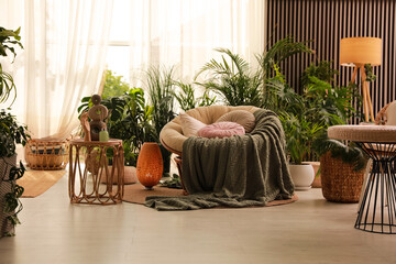 Indoor terrace interior with soft papasan chair and green plants