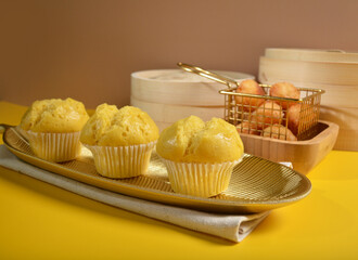 traditional local steam yellow cup cake huat kueh dessert with beautiful display in Pantone color background new asian halal dim sum menu