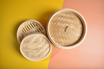 dim sum bamboo basket big and small for steamed food item in yellow background