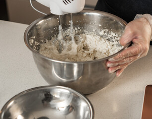 Mixing buttercream in metal bowl