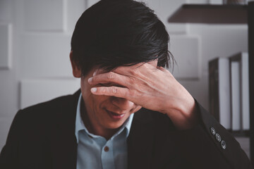 Asian elder business man has the office syndrome problem from hard working. Health care and work life balance concept in working people.