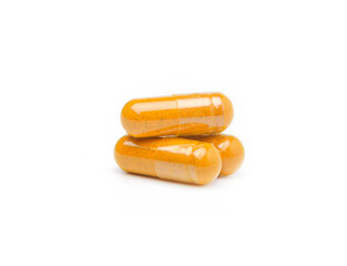 Closeup turmeric herbal powder capsules isolated on white background.