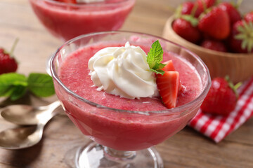 Delicious strawberry mousse with mint on wooden table