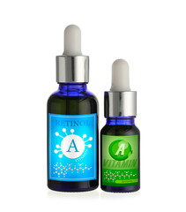 Bottles of vitamin A oil on white background