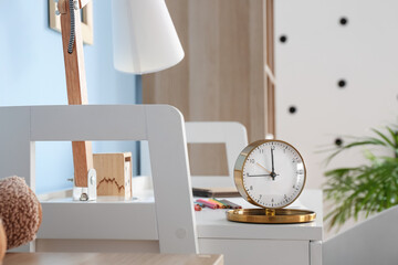 Stylish alarm clock on table, closeup