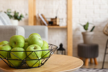 Plate with apples on table in living room, closeup