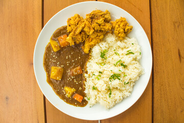 Delicious Curry Rice Chicken with Potato and Carrot On Background Wood Table View on Top