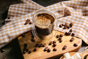 Cup of hot turkish coffee and beans on grunge background
