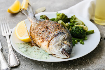 Plate with fried dorado on grunge background
