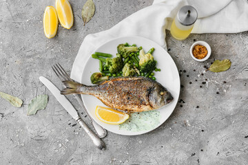 Plate with fried dorado on grunge background