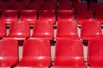 Empty stadium with red rows of chairs