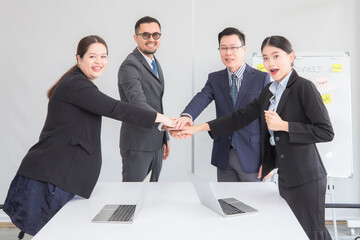 a group of business people shaking hands