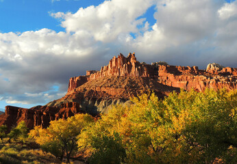 the castle rock formation, changing leaves,  and fremont river in capitol reef national park, utah,...