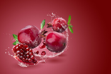 Ripe pomegranate fruit on red background.