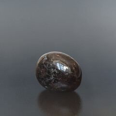 Garnet almondite - polished on white background