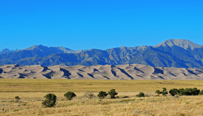 sand dunes and  peaks of the sangre de cristo  mountains on a sunny day  in great  sand dunes...