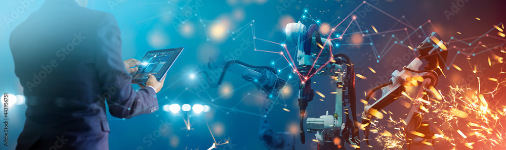 Leinwandbilder Manager engineer check and control automation robot arms machine in intelligent factory industrial on real time monitoring system software. Welding robotics and digital manufacturing operation.