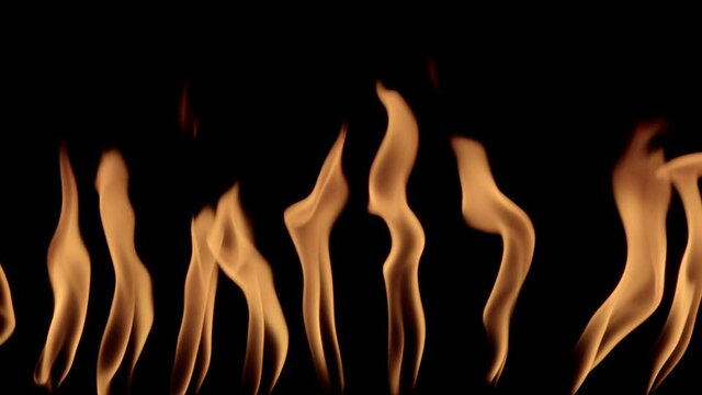 Fiery languages on black background. VFX element. 120 fps slow motion