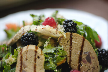 Meat pate slices with herbs and berries