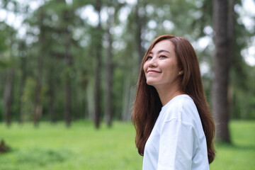 Portrait image of a beautiful asian woman standing in the park