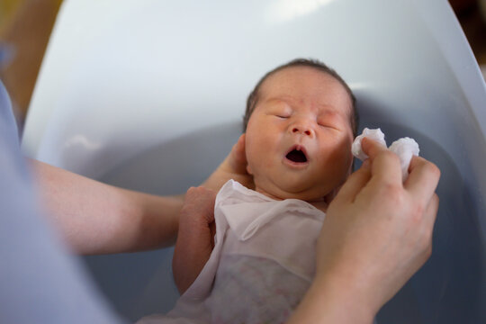 気持ちよく、お風呂に入る新生児（赤ちゃん）