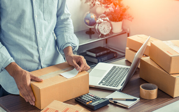 The online seller prepares the delivery post box for the customer.The man online seller.