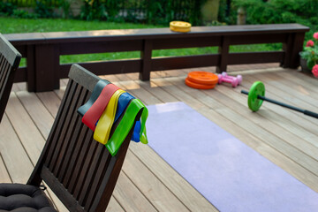 Elastic bands close up. Home training equipment on home yard terrace.