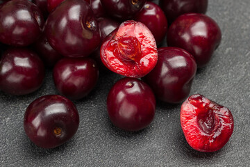 Heap of ripe cherries. Half cherry, pulp and  kernel of cherry