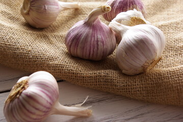 Garlic on a linen napkin on a wooden table