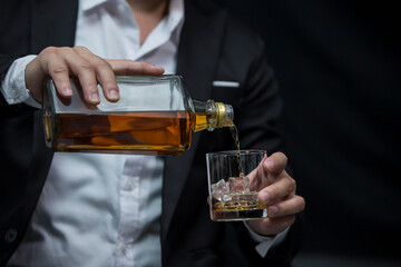 Closeup businessmen holding a glass of whiskey
