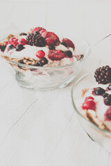 Granola with yogurt, strawberries, blackberries and blueberries. Vintage Instagram style effect