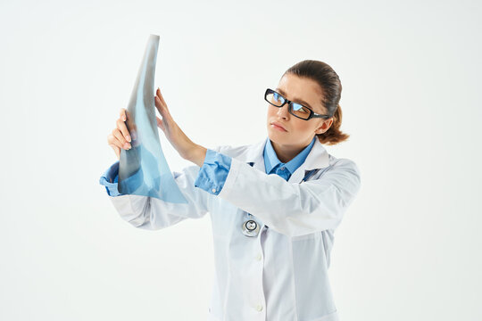 woman doctor in white coat looking at x-ray diagnostics close-up