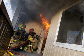 Firefighters trying to put out flames cabin on fire