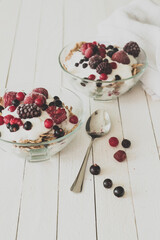 Granola with yogurt, strawberries, blackberries and blueberries. Vintage Instagram style effect
