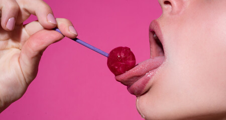 Woman licking lollipop, art banner, red lips with lollipop. Sexy red female mouth and tongue with...