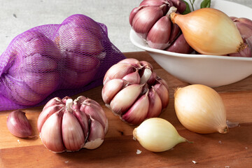 Garlic and onion on cutting board.