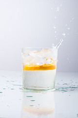 Orange fell in a glass with water isolated on white