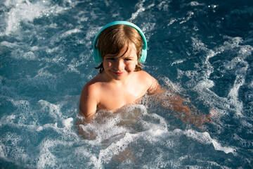 Child swimming. Kids summer vacation in swimming pool.